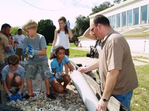 "Put 'em to work!" Young visitors bag oyster shells for future use restoring an oyster reef. 