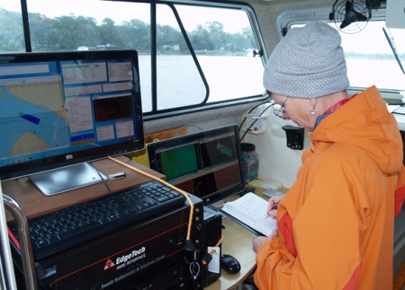 Skidaway Institute of Oceanography research coordinator Claudia Venherm logs survey activity on board the R/V Jack Blanton